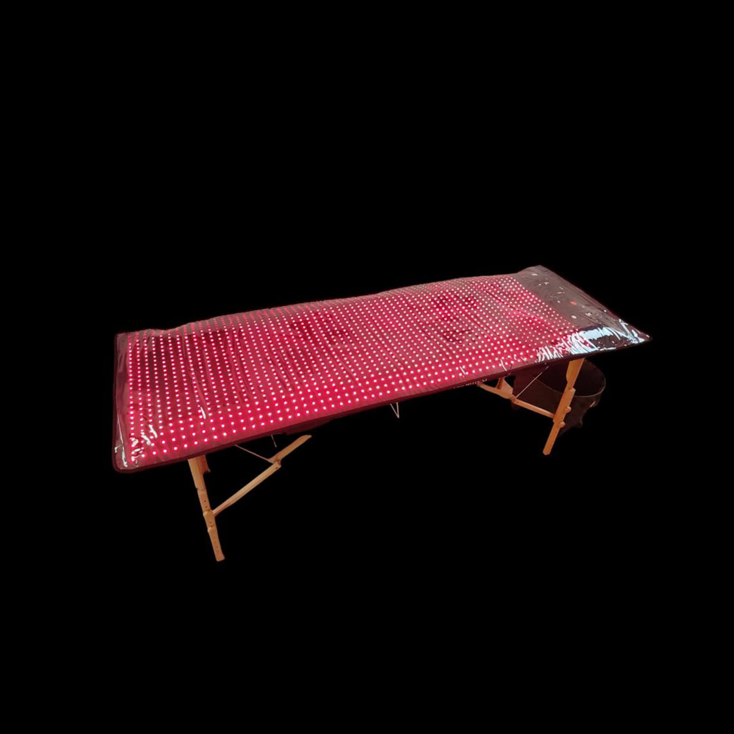 Red LED grow light panel on a foldable wooden stand against a black background, designed for indoor gardening.