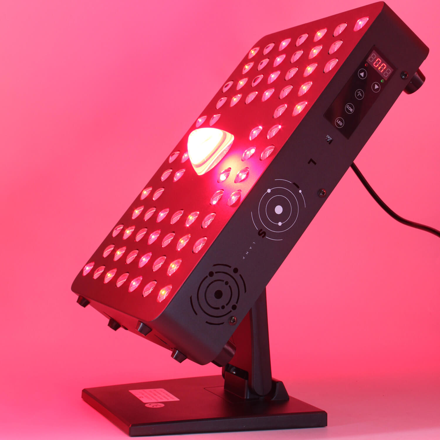 LED grow light panel on a stand emitting bright pink/red light with a grid of diodes and a control panel nearby