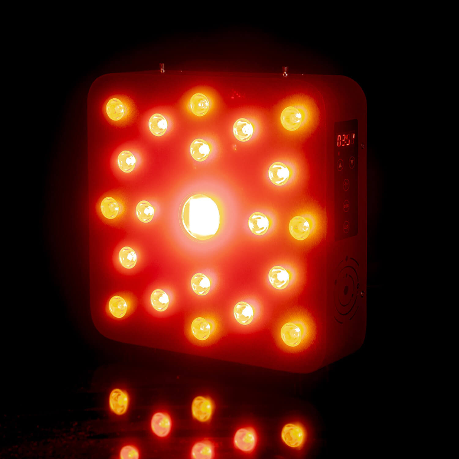 Bright red LED panel with many small bulbs glowing, set against a dark background; a digital control panel is visible on the right side.