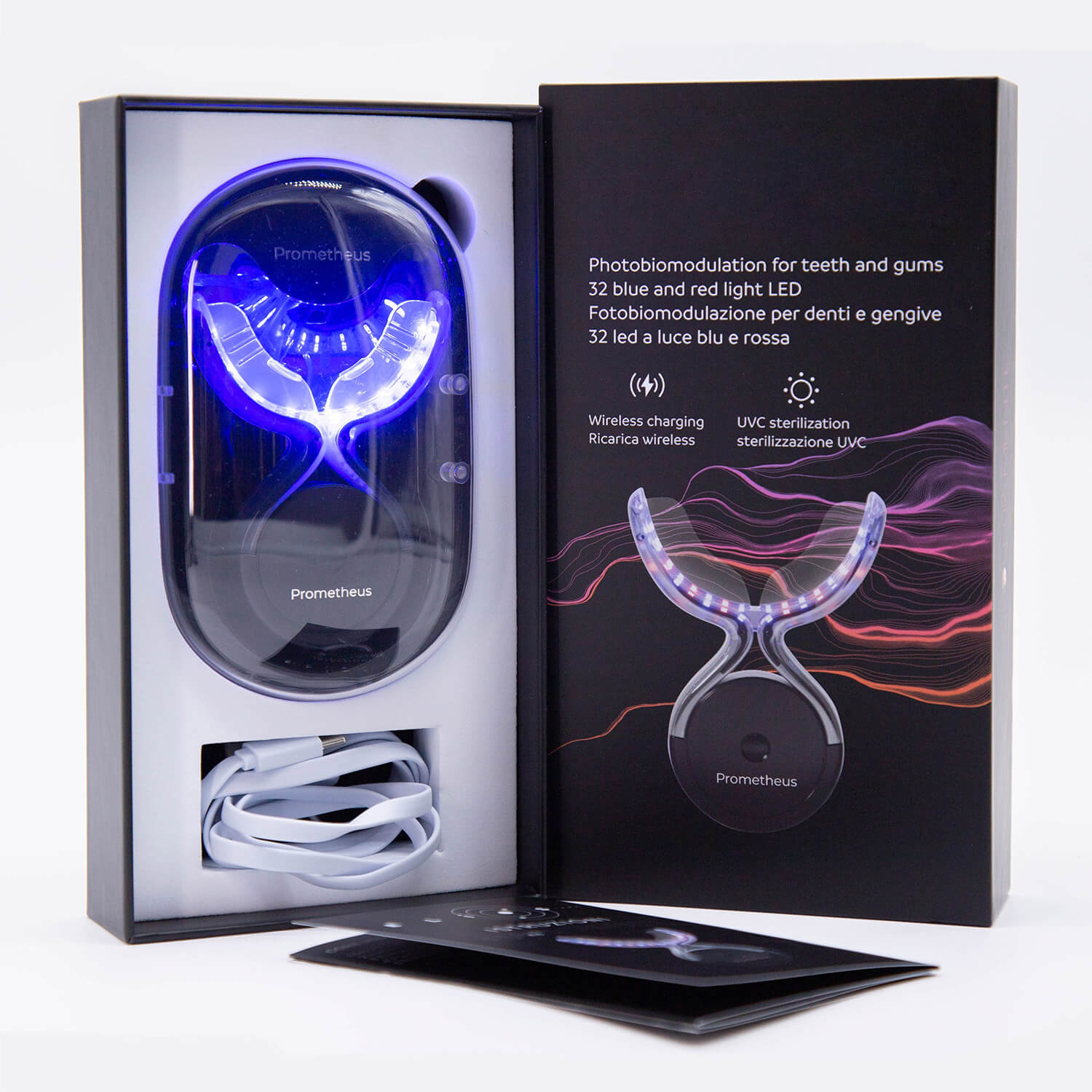 Blue, curved photobiomodulation device in open box with cables coiled below, brand Prometheus visible on device panel.