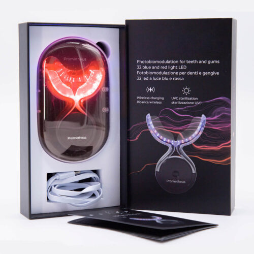 Prometheus photobiomodulation device in an open box with a red LED mouthpiece and a white USB cable nearby.