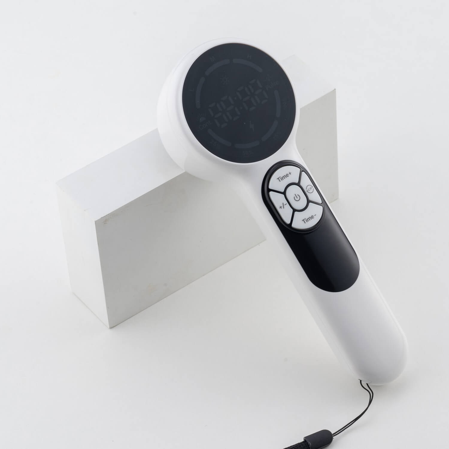 White handheld device with a large circular black display at the top and a detachable remote control on the handle, resting on a white surface.