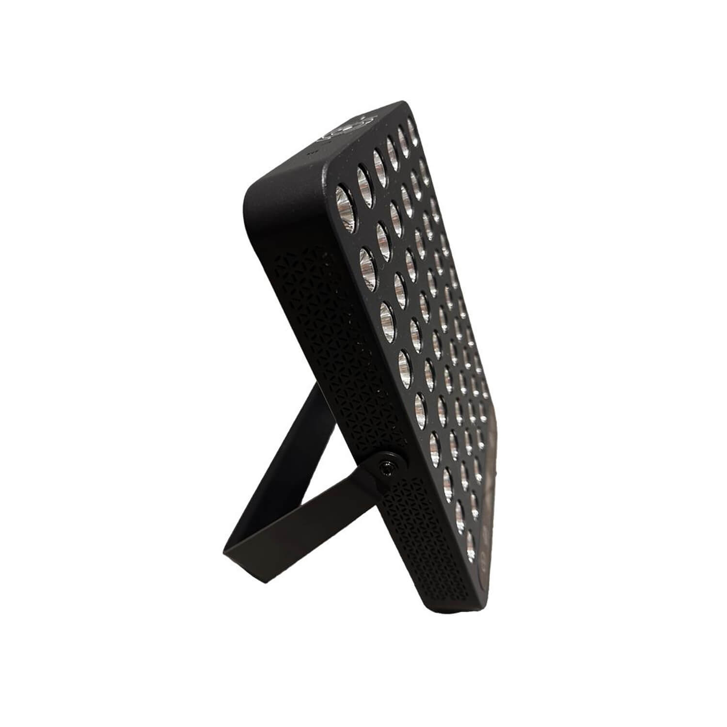 Close-up of a black metal floodlight with circular perforations on the front panel, angled upward with a mounting arm visible.