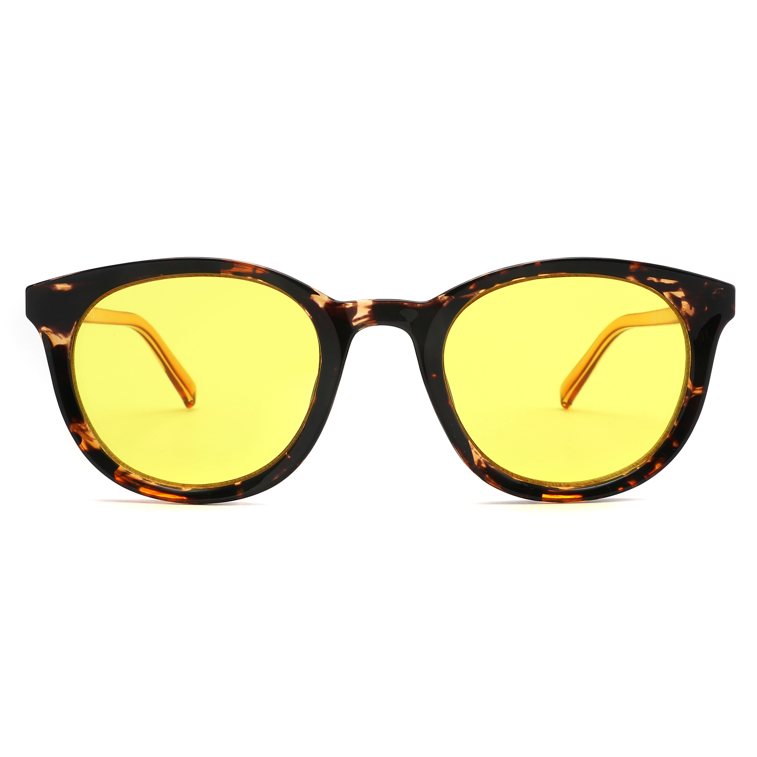 Close-up of tortoiseshell sunglasses with yellow lenses, shown from a low angle at the bottom of the frame